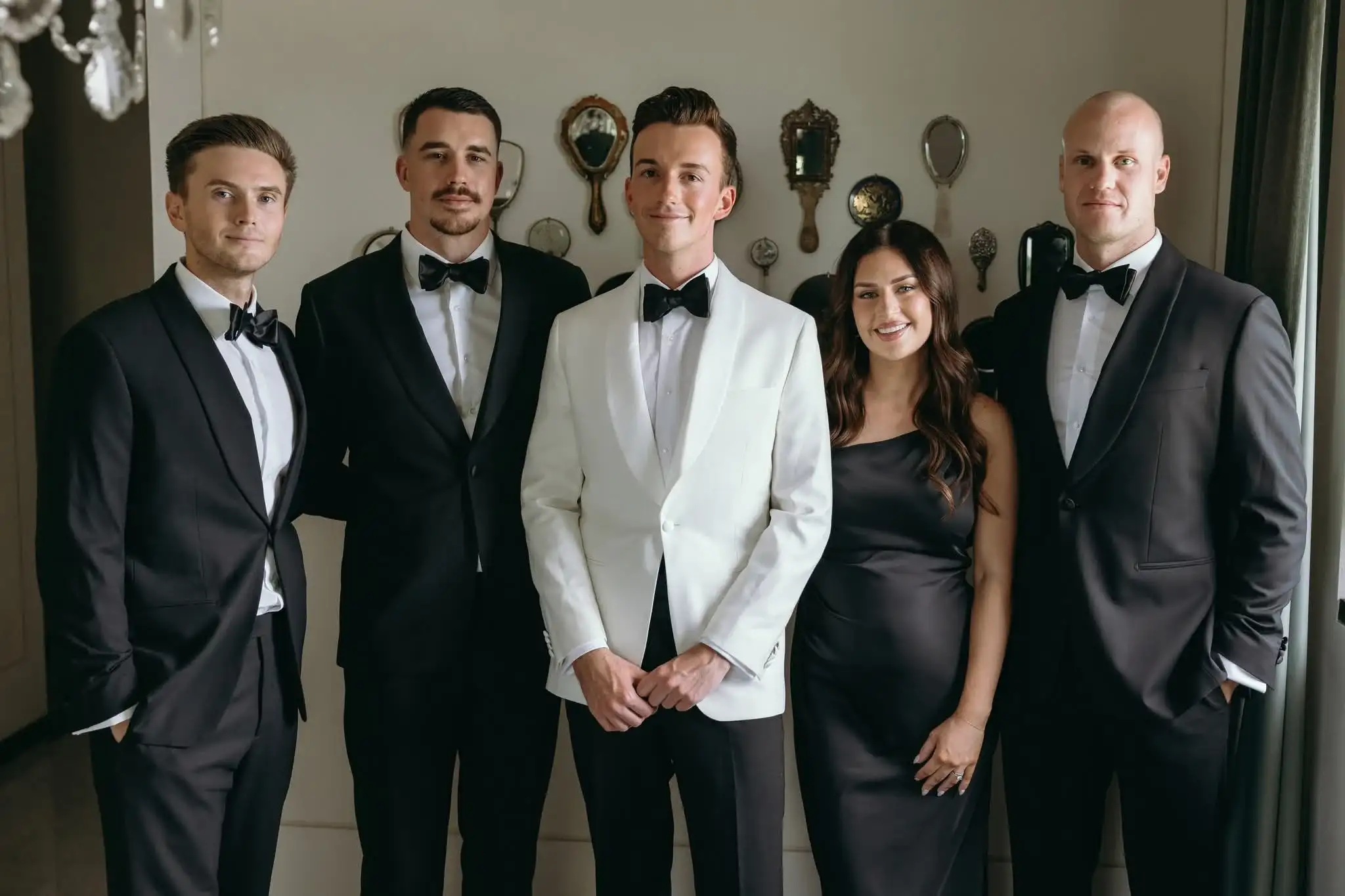 Group of clients dressed in bespoke tuxedos at formal event