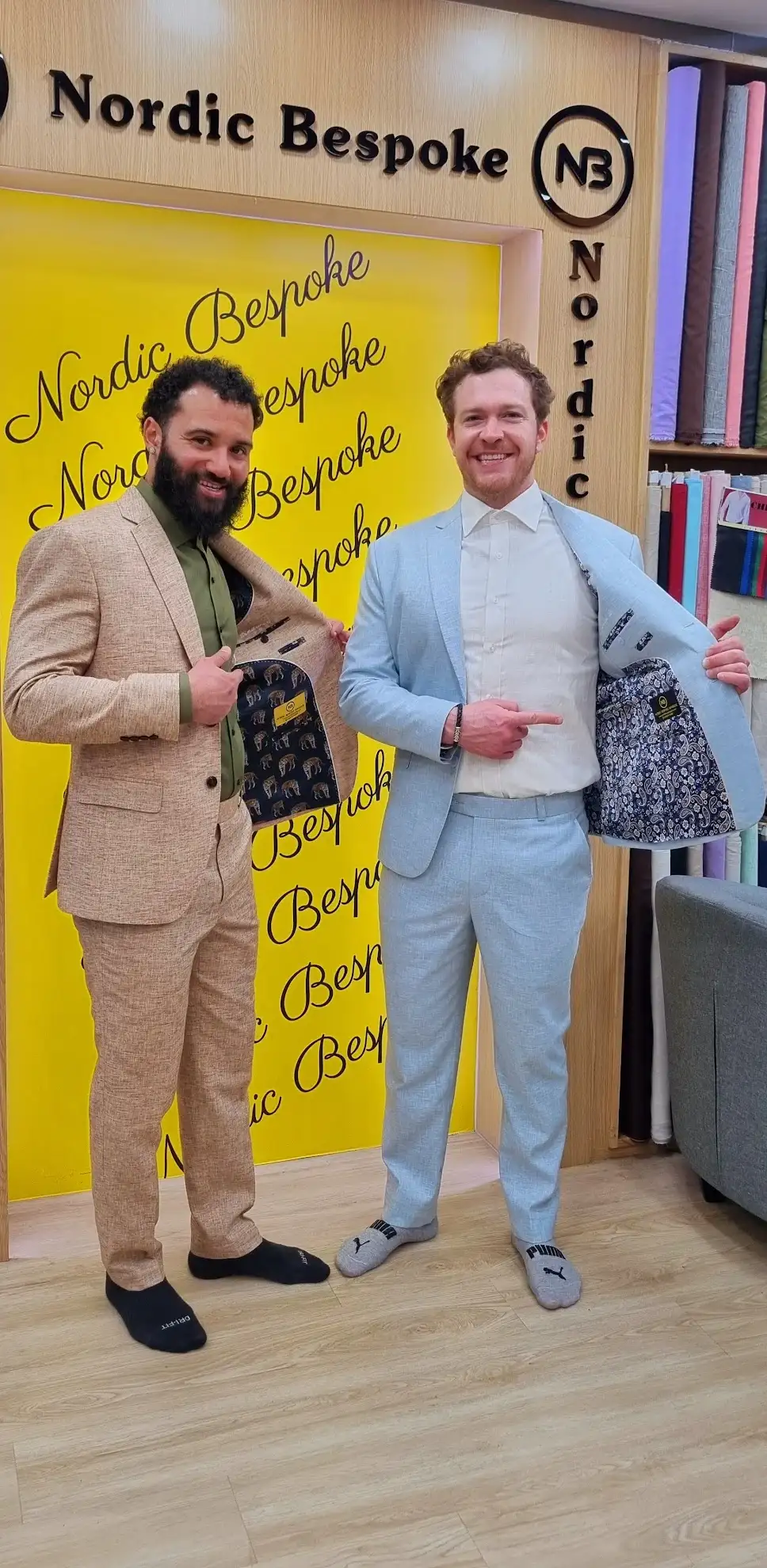 Two clients wearing beige and light blue bespoke suits at Nordic Bespoke Tailor