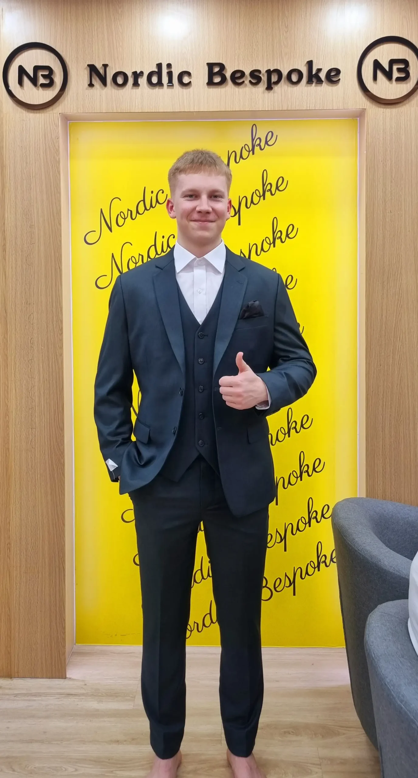 Customer wearing a dark three-piece suit in the showroom