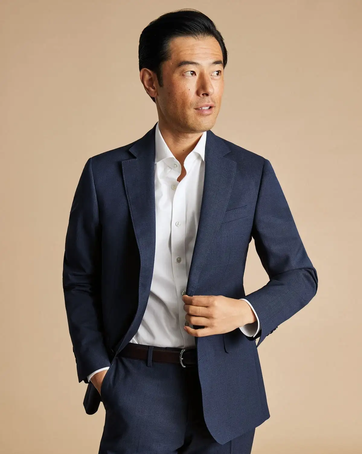 Man wearing a navy blazer with a white shirt