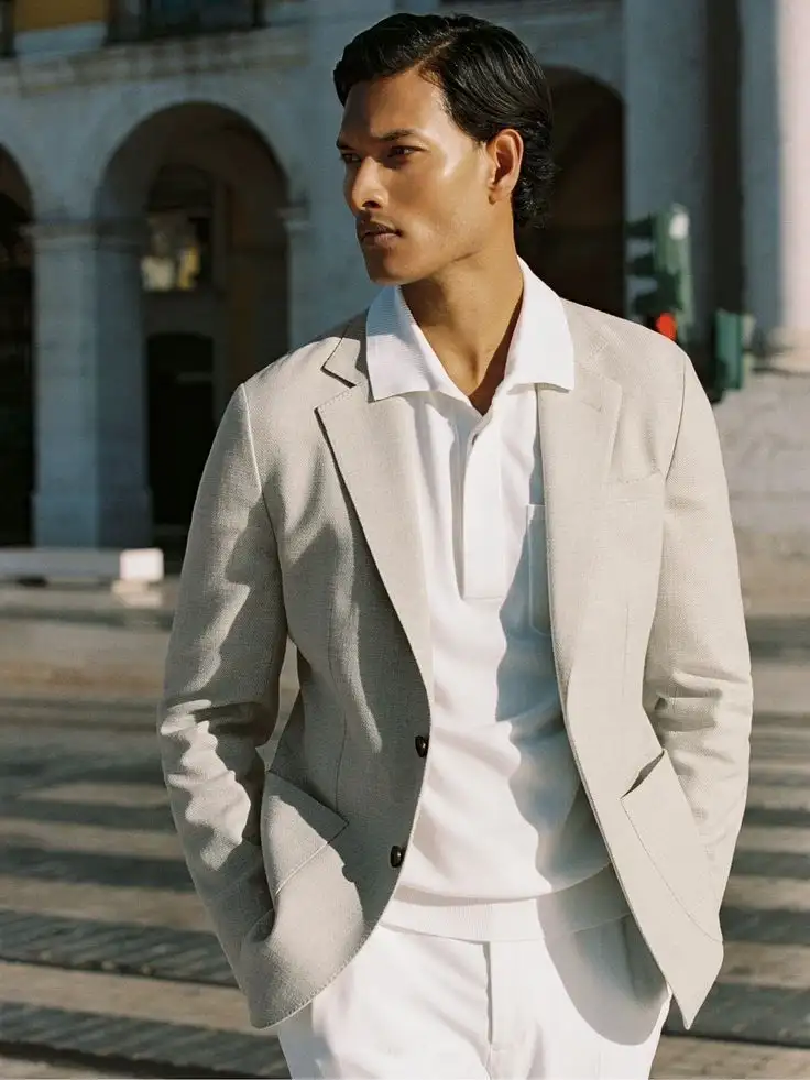 Man wearing a cream blazer with a white shirt