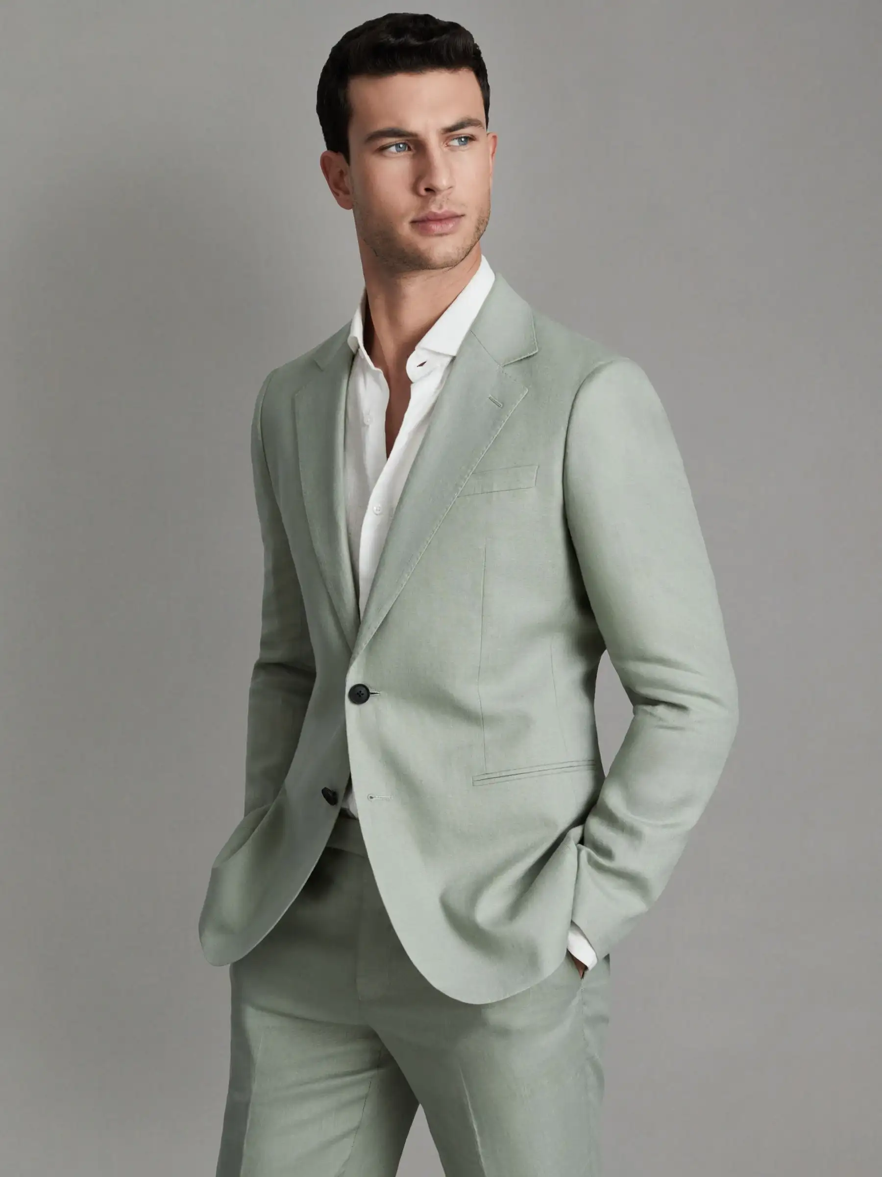 Male model wearing light green blazer with modern slim fit