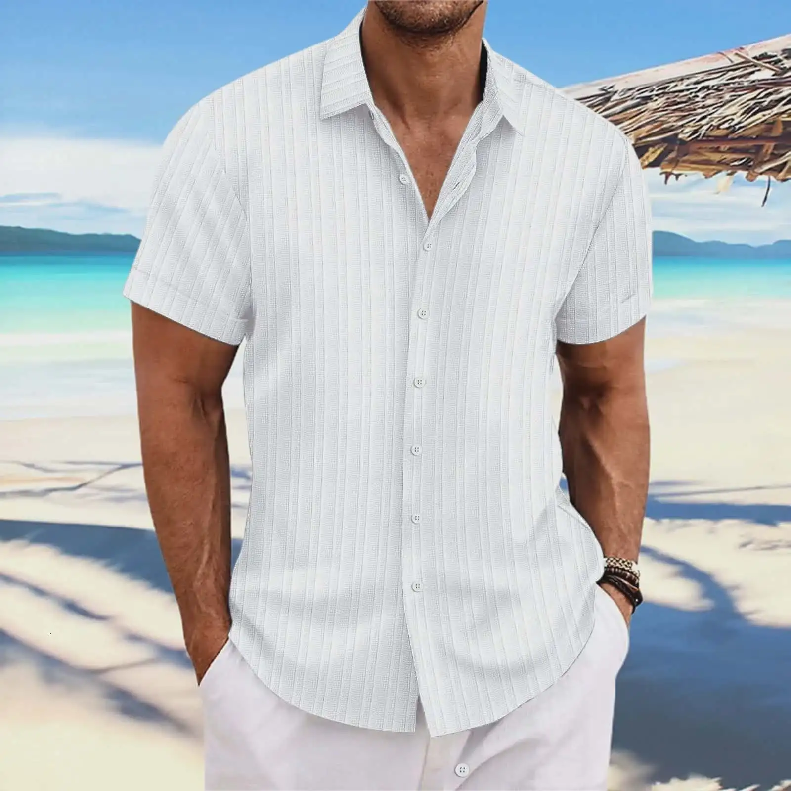 Man wearing a white short-sleeved shirt with white trousers