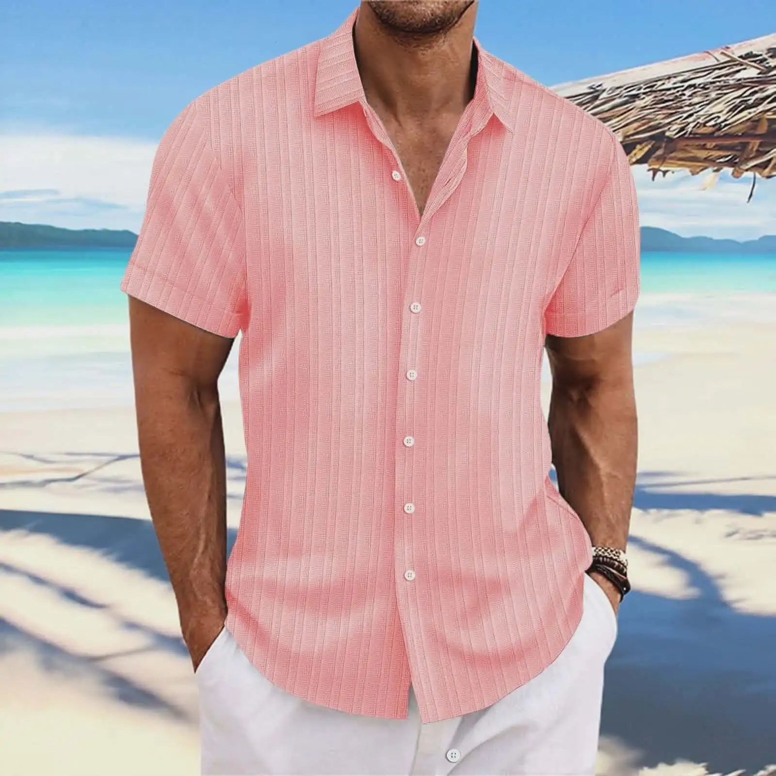 Man wearing a pink short-sleeved shirt with white trousers