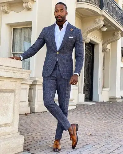 Man wearing a blue checked suit with brown shoes