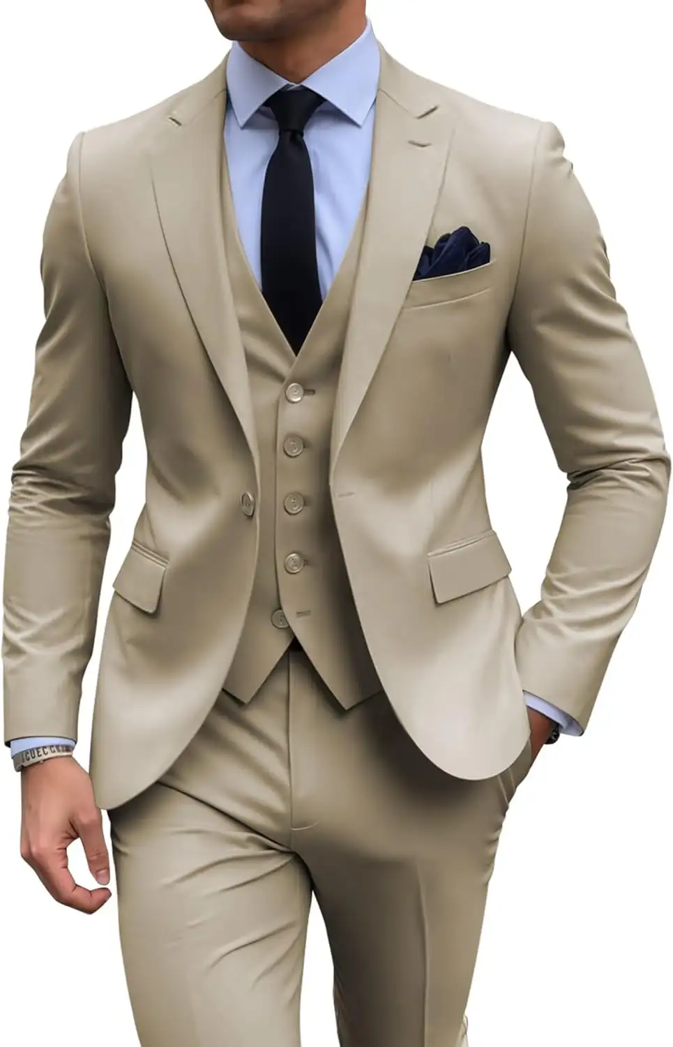 Man wearing a beige three-piece suit with a navy tie