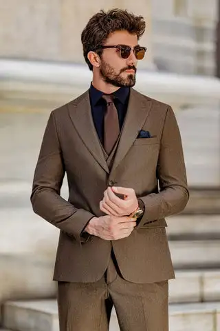 Man wearing a brown suit with a dark shirt