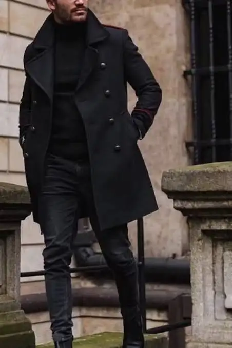 Man wearing a black double-breasted overcoat with a black outfit