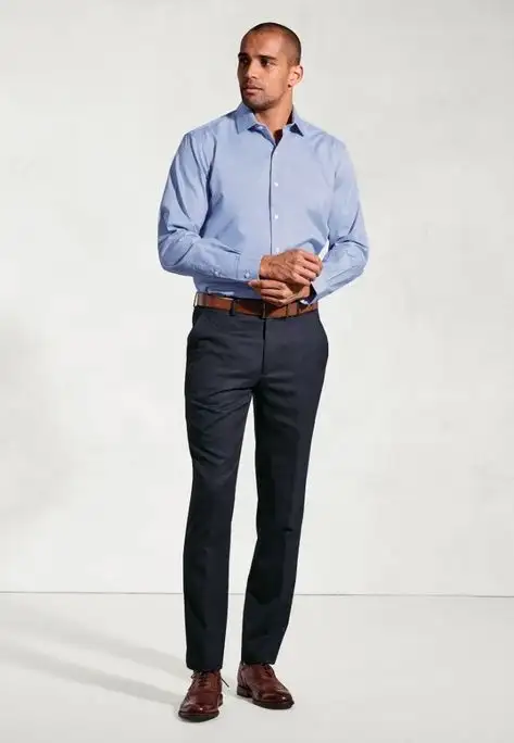 Male model wearing crisp white long-sleeve dress shirt tucked into dark trousers – Nordic Bespoke Tailor formal shirt