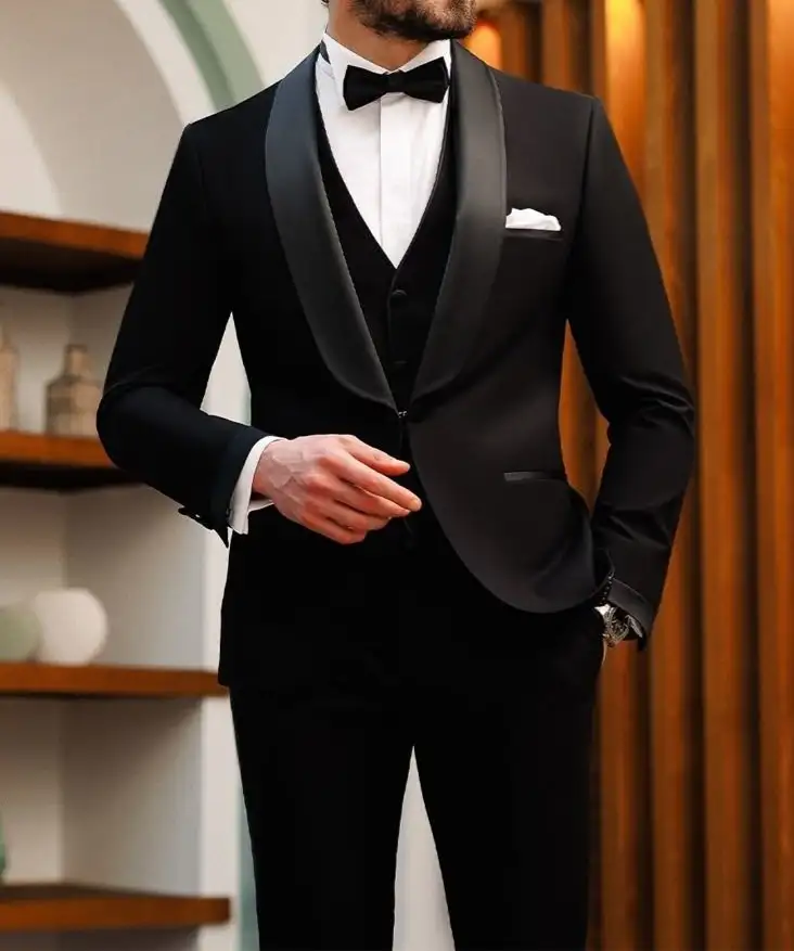 Black tuxedo with a waistcoat, white shirt and black bow tie