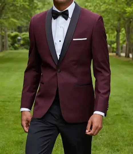 Man wearing a burgundy tuxedo jacket with black trousers