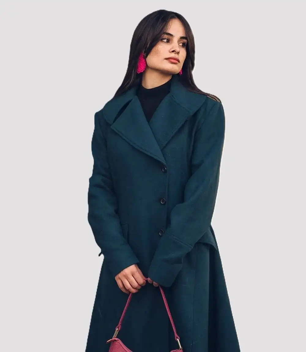 Women’s dark green overcoat showcasing minimalist bespoke tailoring