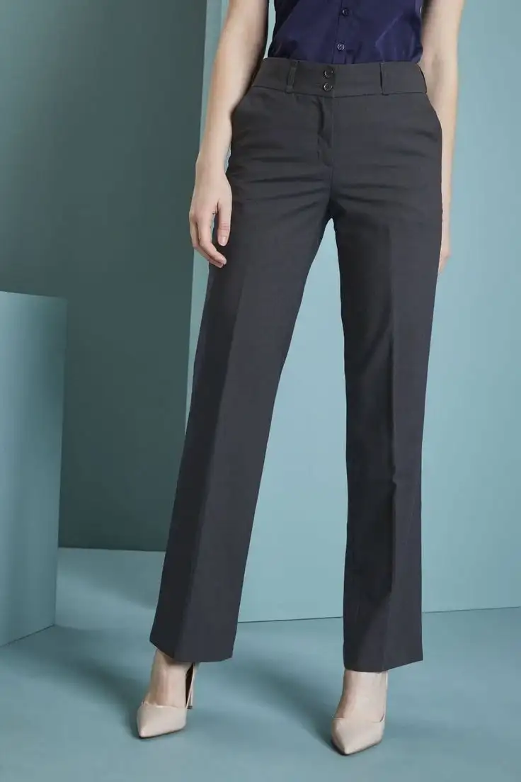 Woman wearing dark navy straight-leg dress trousers paired with a tucked-in navy blouse and beige high heels – bespoke women's professional pant style