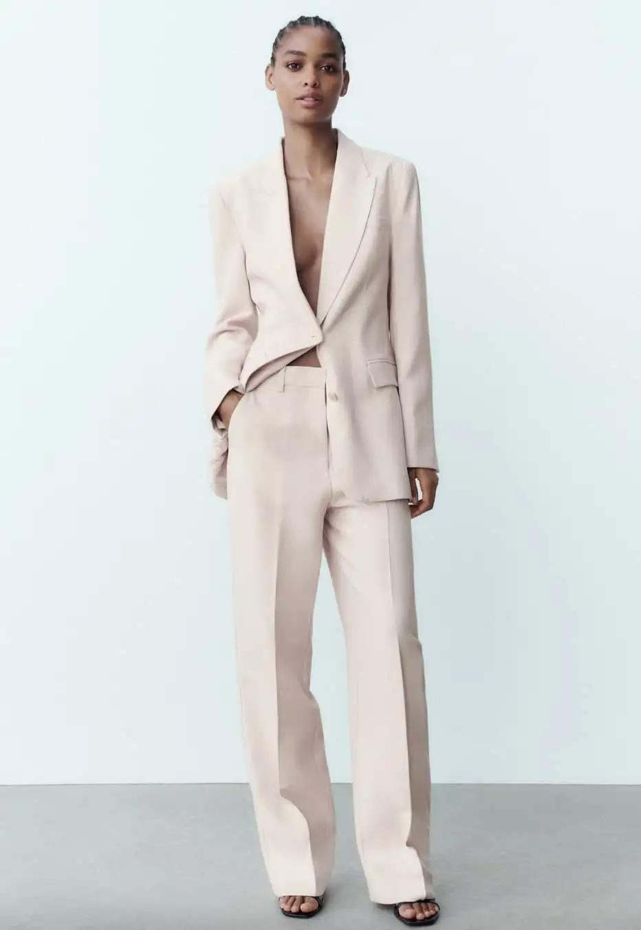 Woman wearing a pale beige trouser suit