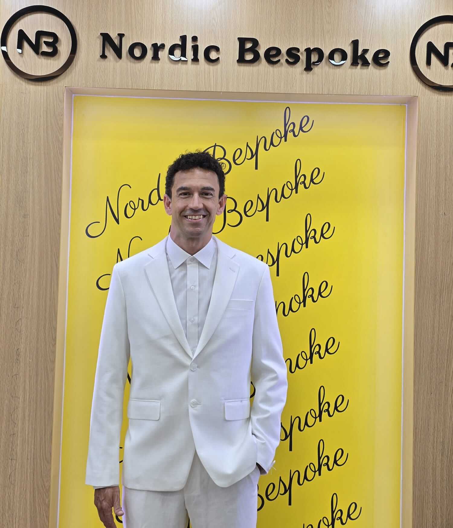 Customer wearing a white suit in the showroom
