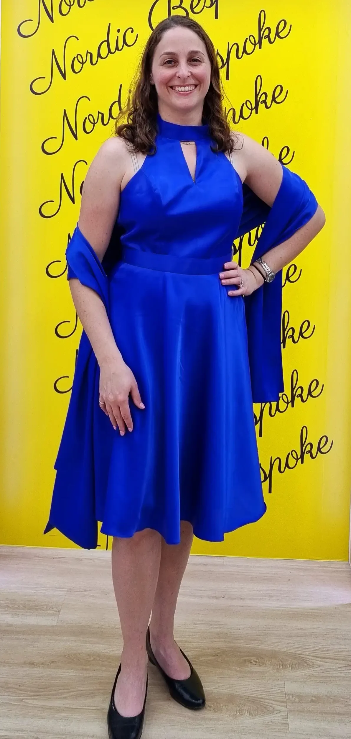 Customer wearing a blue knee-length dress in the showroom