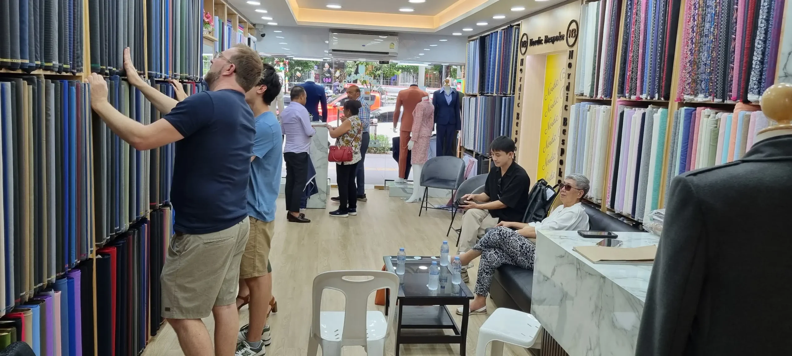 Inside Nordic Bespoke Tailor store showing customers and tailoring consultation area