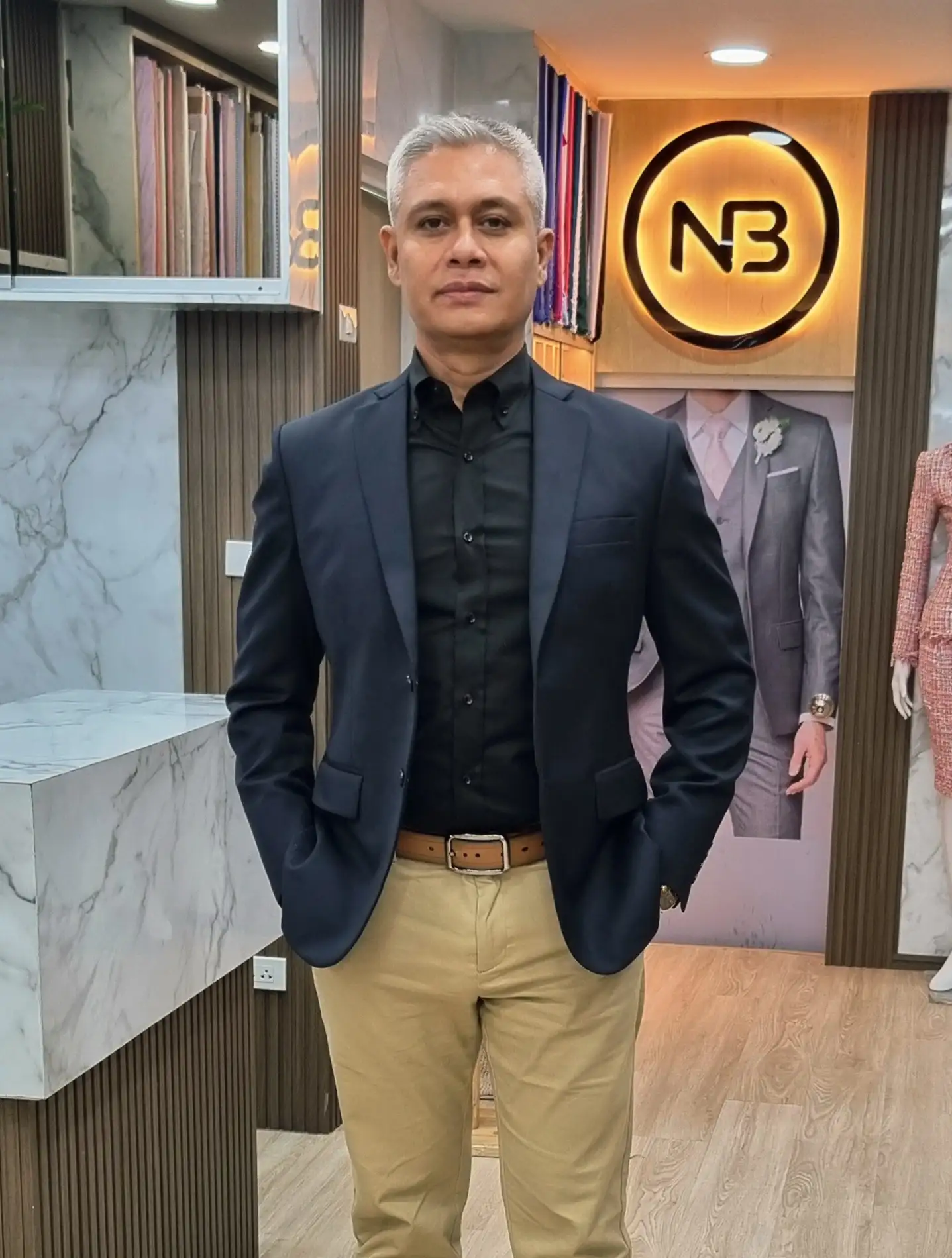 Founder wearing dark tailored blazer and trousers inside Nordic Bespoke Tailor showroom